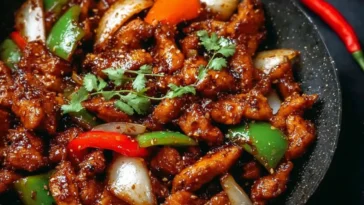 Black Pepper Chicken Plated with Fresh Herbs