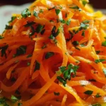 Raw Carrot Salad garnished with fresh herbs