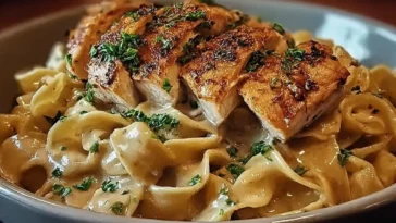 Delicious Chicken with Buttered Noodles on a Plate