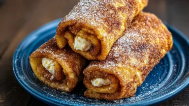 Cinnamon Sugar French Toast Roll-Ups Plated with Syrup