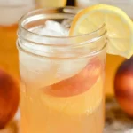 Delicious Peach Lemonade in a Glass with Fresh Peaches