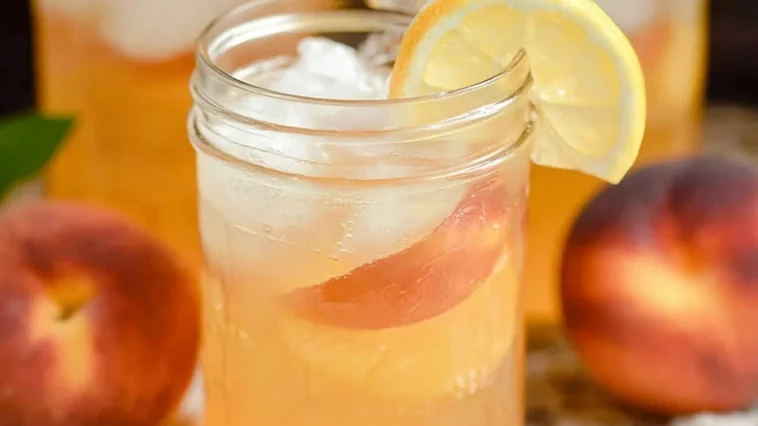 Delicious Peach Lemonade in a Glass with Fresh Peaches