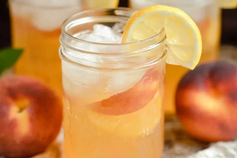 Peach Lemonade: Refreshing Summer Drink You’ll Love 3 Delicious Peach Lemonade in a Glass with Fresh Peaches