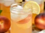 Delicious Peach Lemonade in a Glass with Fresh Peaches