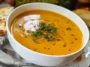 Pumpkin Carrot Soup in a Bowl with Fresh Herbs