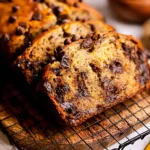 Easy Chocolate Chip Banana Bread that's Irresistibly Delicious 5 Slice of Easy Chocolate Chip Banana Bread on a Plate