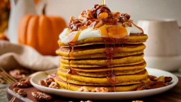 Fluffy Pumpkin Pancakes Drizzled with Maple Syrup