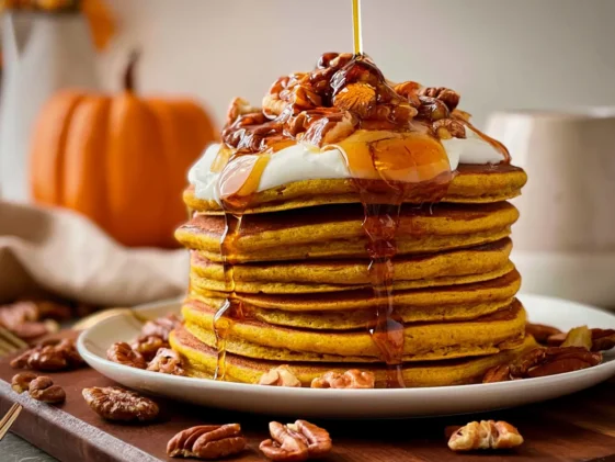 Fluffy Pumpkin Pancakes Drizzled with Maple Syrup