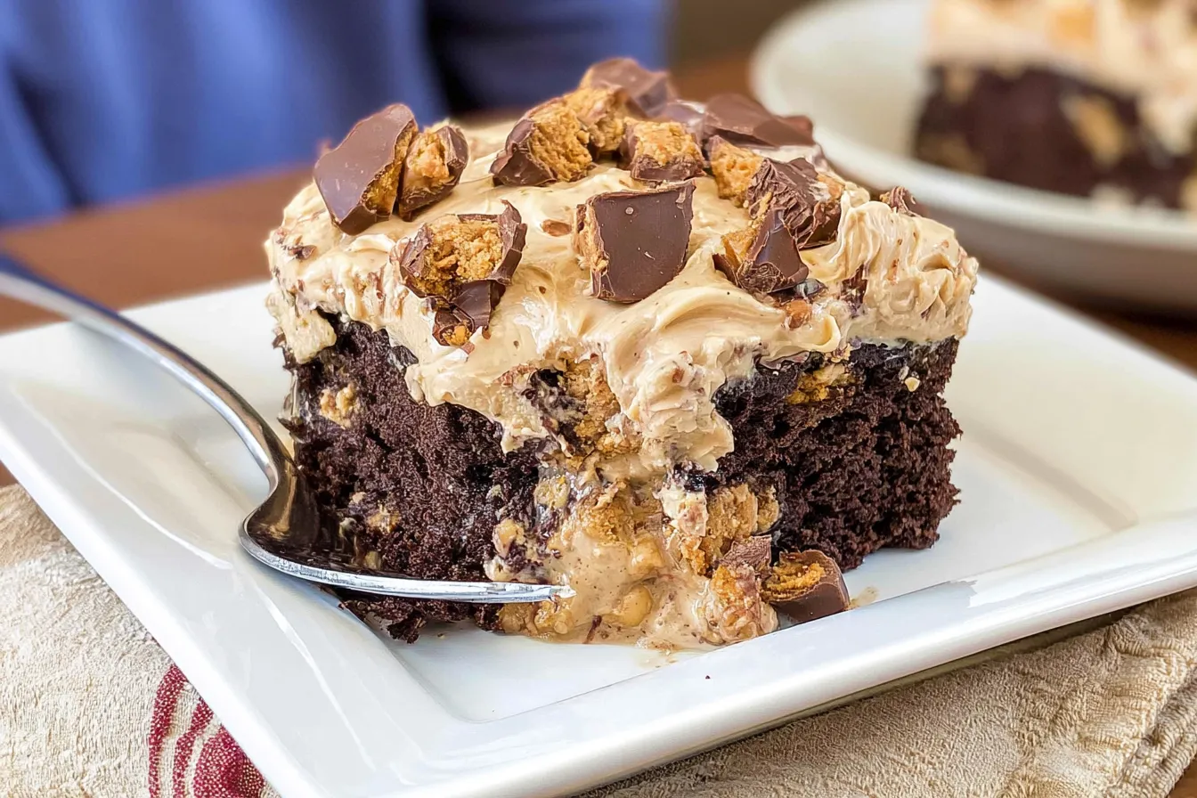 Delicious Reese’s Peanut Butter Cup Poke Cake on a plate